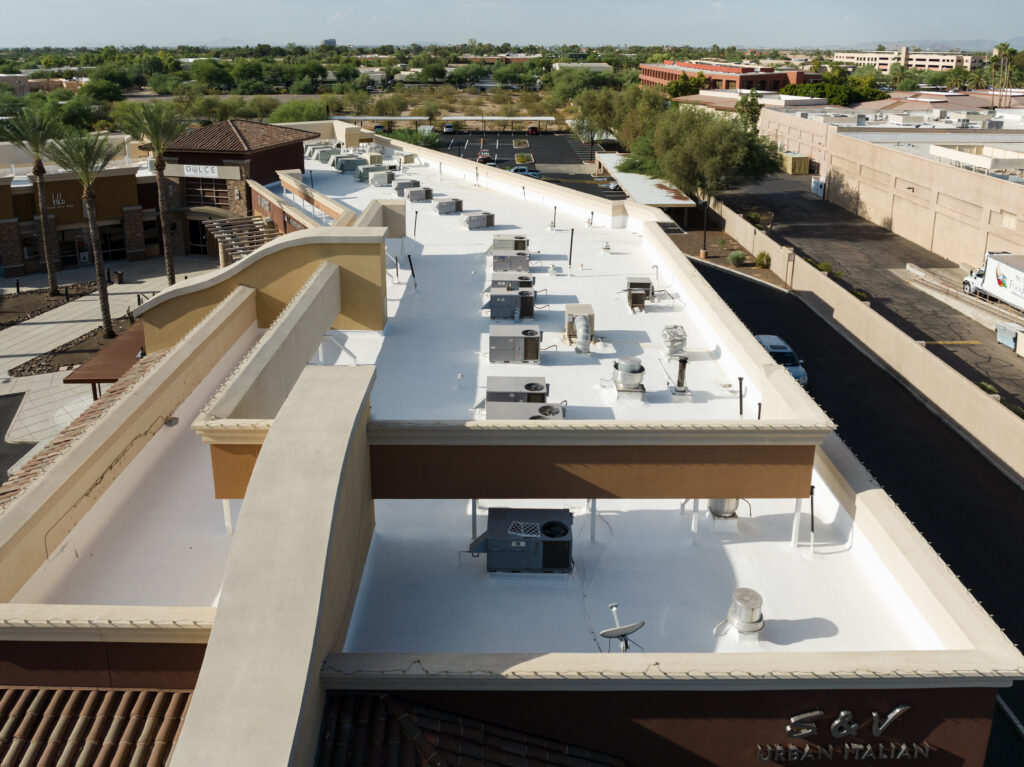 A commercial building with a newly replaced roof with multiple mechanical units