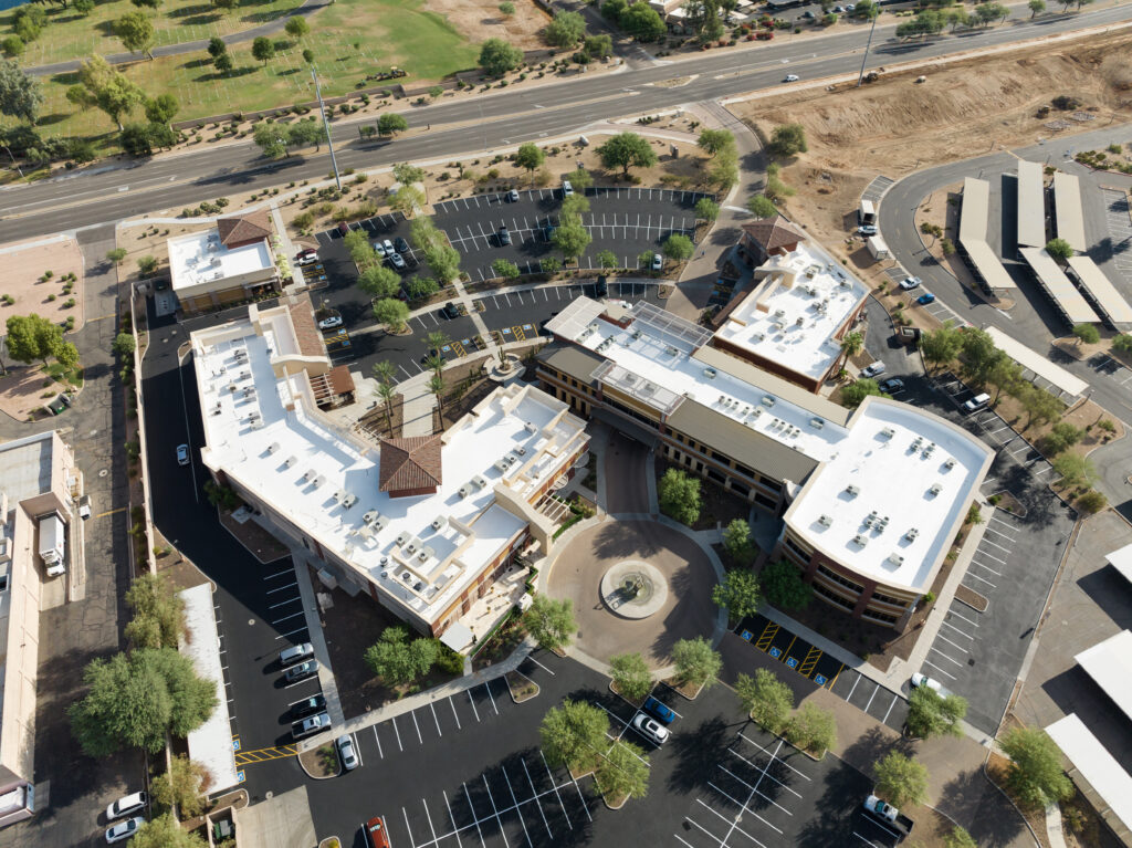 An aerial view of a large commercial building with a newly replace roof with multiple mechanical units